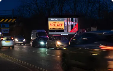 A brightly lit digital billboard in a high traffic area