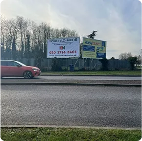 Two billboards at beside a large road