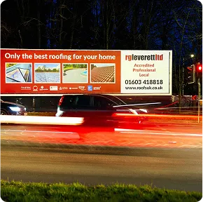 A large billboard beside a busy road