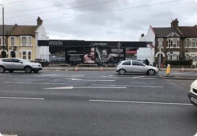 A roadside billboard in a busy urban area